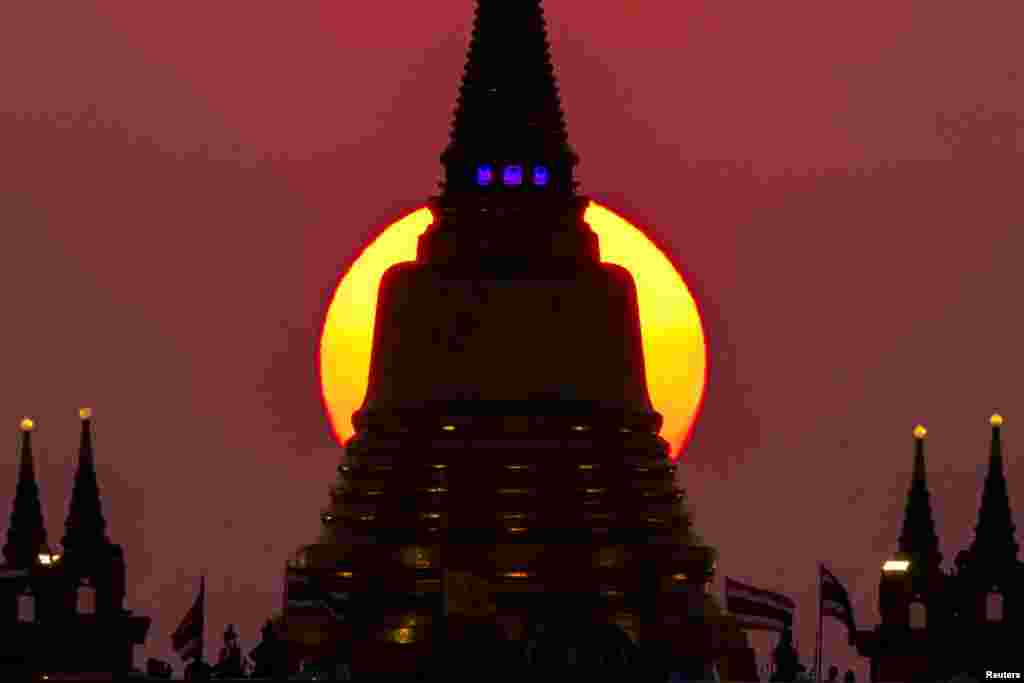 The sun sets behind Wat Saket Temple, or Golden Mount, in Bangkok, Thailand, March 15, 2022.