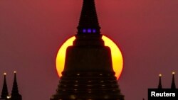The sun sets behind Wat Saket Temple, or Golden Mount in Bangkok, Thailand, March 15, 2022.