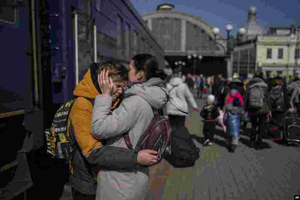 A mother embraces her son who escaped the besieged city of Mariupol and arrived at the train station in Lviv, western Ukraine.