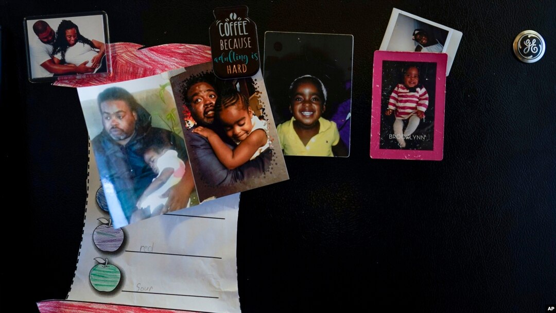 Family photos of Danielle Mitchell and Rodney Chiles and their daughter, Brooklynn Chiles, decorate the kitchen refrigerator in Washington, Feb. 9, 2022.