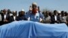 Relatives and Somali government officials pray near the slain body of Amina Mohamed Abdi, a vocal critic of the government, who was killed in a suicide explosion in Beledweyne, at the Adan Abdulle International Airport international in Mogadishu, Somalia, March 24, 2022.