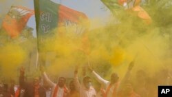 Supporters of India's rolling Bharatiya Janata Party(BJP) celebrate after their party's victory in state elections, in Ahmedabad, India, March 10, 2022. 