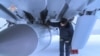 FILE - This handout video grab released by the Russian Defense Ministry on Feb. 19, 2022, shows an airman examining a MiG-31K fighter jet of the Russian air force carrying a Kinzhal hypersonic missile at an undisclosed location in Russia.