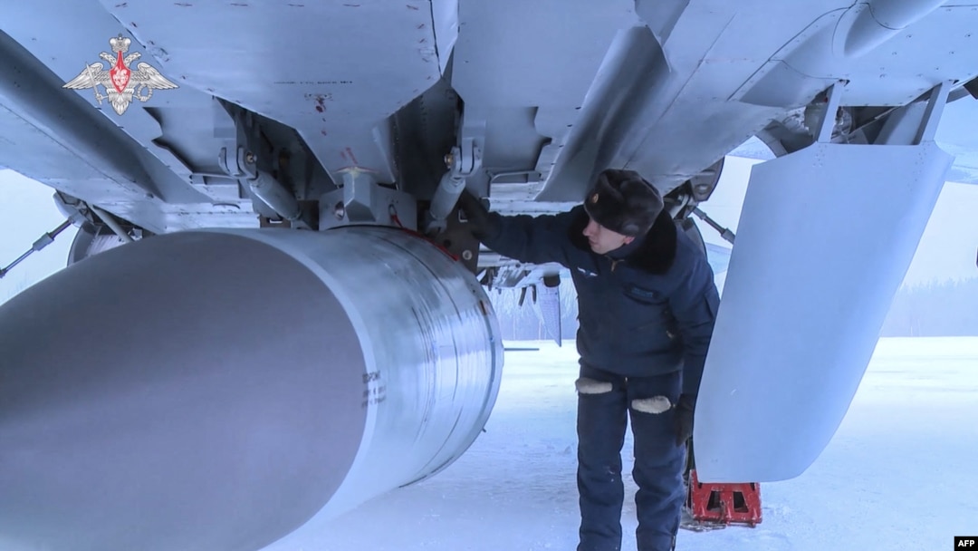 FILE - This handout video grab released by the Russian Defense Ministry on Feb. 19, 2022, shows an airman examining a MiG-31K fighter jet of the Russian air force carrying a Kinzhal hypersonic missile at an undisclosed location in Russia.