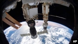 FILE - This Dec. 6, 2021, photo provided by NASA shows the International Space Station above the Tyrrhenian Sea with the Soyuz MS-19 crew ship docked to the Rassvet module.