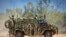 FILE - In this photo provided by the Australian Defense Force, an Australian Army Bushmaster armored vehicle moves off road during a training mission July 7, 2021, in Townsville, Australia. 