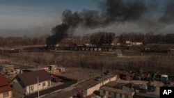 Smoke billows from burning containers after shelling in Vasylkiv, south west of Kyiv, Ukraine, March 12, 2022.