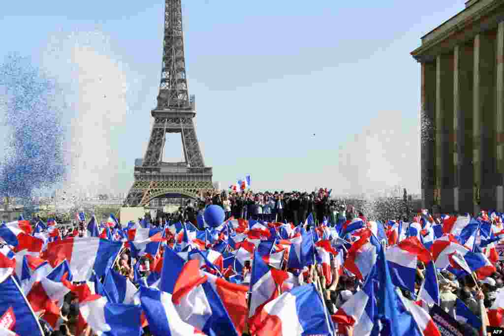 French far-right Reconquete! party president and presidential candidate Eric Zemmour (C) stands with supporters and allies on stage at the end of a campaign rally on the Trocadero square in Paris.