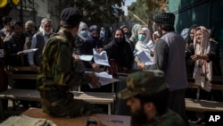 Afghans gather at the government passport office in Kabul, Afghanistan, Oct. 17, 2021. 