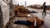 The body of a person, with hands tied behind his or her back, lies in a street, amid Russia's invasion on Ukraine, in Bucha, near Kyiv, April 3, 2022. According to local residents, the person was shot by retreating Russian soldiers.