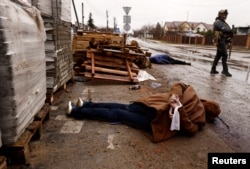 The body of a person, with hands tied behind his or her back, lies in a street, amid Russia's invasion on Ukraine, in Bucha, near Kyiv, April 3, 2022. According to local residents, the person was shot by retreating Russian soldiers.