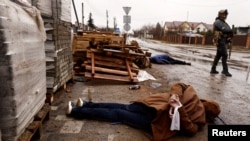 The body of a person, with hands tied behind his or her back, lies in a street, amid Russia's invasion on Ukraine, in Bucha, near Kyiv, April 3, 2022. According to local residents, the person was shot by retreating Russian soldiers.