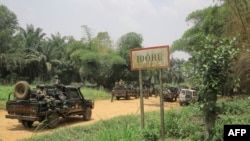 FILE - A convoy of Armed Forces of the Democratic Republic of Congo soldiers are seen in the village Idohu on the Beni-Komanda axis, March 19, 2022. 