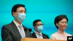 This file photo shows, from right, Hong Kong's Chief Executive Carrie Lam, Secretary for Security Chris Tang and Chief Secretary John Lee attend a news conference in Hong Kong, on June 25, 2021. (AP Photo/Kin Cheung, File)