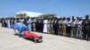 Political leaders pray in front the two bodies of the local lawmakers including Amina Mohamed Abdi after being airlifted from Beledweyne, at Aden Adde International Airport in Mogadishu, Somalia, on March 24, 2022.