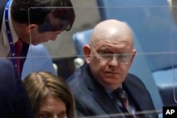 Russia Ambassador Vassily Nebenzia, right, confers during a meeting of the United Nations Security Council on the humanitarian crisis in Ukraine, at U.N. headquarters. March 17, 2022.