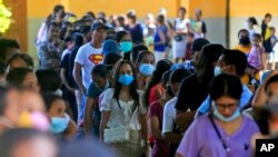 People line up at a polling station to vote during the presidential election in Dili, East Timor, March 19, 2022.