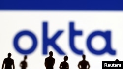 People's Miniatures of people are seen in front of Okta logo in this illustration taken March 22, 2022. 