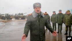 FILE - Belarusian President Alexander Lukashenko gestures while speaking to journalists at the Osipovichi training ground during Russia-Belarus military drills near Osipovichi, Belarus, Feb. 17, 2022.