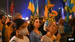 FILE - Members of the Ukrainian Australian community and supporters participate in a protest against Russia’s invasion of Ukraine, at the Sydney Opera House, in Sydney, March 1, 2022. 
