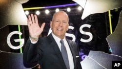 FILE - Actor Bruce Willis poses for photographers upon arrival at the premiere of the film 'Glass', in London, Jan. 9, 2019.