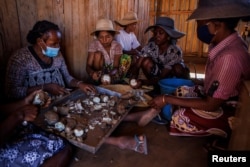 Members of the women's association chop cassava at the association's workshop in the town of Ambovombe, Androy region, Madagascar, February 14, 2022. (REUTERS/Alkis Konstantinidis )