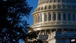 FILE - Sunlight shines on the U.S. Capitol dome on Capitol Hill in Washington, Sept. 30, 2021.