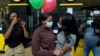 South African student Vutlhari Mtonga, center-left, who was evacuated from Ukraine following Russia's invasion of the country, is welcomed by her sister Mikateko Mtonga, on arrival at OR Tambo International Airport, in Johannesburg, South Africa, March 10