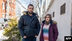 Afghani evacuees Israr, 26, and his pregnant wife Sayeda, 23, stand together in Charlestown, Massachusetts on February 21, 2022.