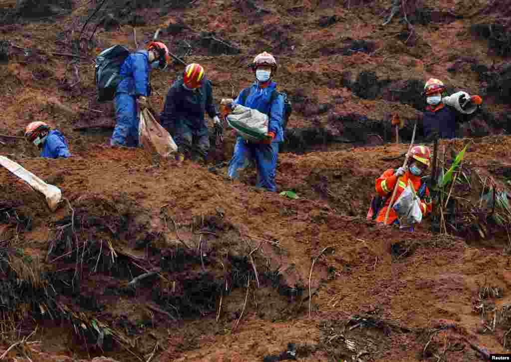 Rescue workers work at the site where a China Eastern Airlines Boeing 737-800 plane flying from Kunming to Guangzhou crashed, in Wuzhou, Guangxi Zhuang Autonomous Region.