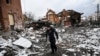 A man walks between houses destroyed during air strikes on the central Ukranian city of Bila Tserkva on March 8, 2022.