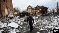 A man walks between houses destroyed during air strikes on the central Ukranian city of Bila Tserkva on March 8, 2022.