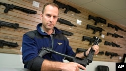 Adrian Kellgren, director of industrial production of KelTec, holds a 9mm SUB2000 rifle, similar to ones being shipped to Ukraine, at the company's manufacturing facility, March 17, 2022, in Cocoa, Fla. 