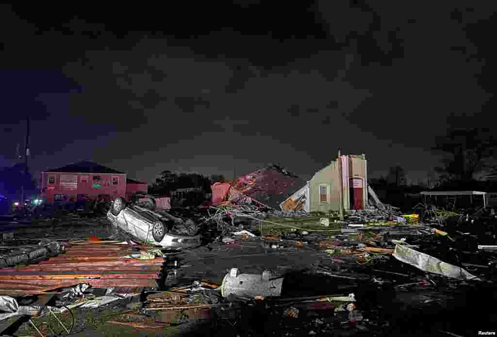 A car lies overturned among debris in the Arabi neighborhood after a large tornado struck New Orleans, Louisiana, March 22, 2022.