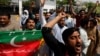 Supporters of the Pakistan Tehreek-e-Insaf (PTI) political party, chant slogans in support of Pakistani Prime Minister Imran Khan, outside parliament building Islamabad, Apr. 3, 2022. 
