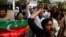 Supporters of the Pakistan Tehreek-e-Insaf (PTI) political party, chant slogans in support of Pakistani Prime Minister Imran Khan, outside parliament building Islamabad, Apr. 3, 2022. 