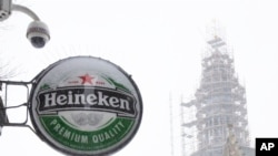 A Heineken sign sits on the facade of a bar, closed because of the coronavirus lockdown in Amsterdam, Sunday, Feb. 7, 2021.