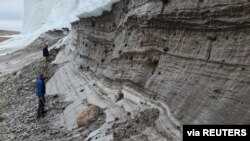 Scientists perform research field work at the edge of the Greenland Ice Sheet while studying the age of the 31-km-wide Hiawatha impact crater, buried under ice six-tenths of a mile (1 km) thick in 2019. (Shfaqat Abbas Khan/Handout via REUTERS)