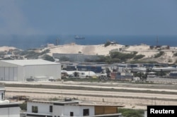 Smoke billows from shipping containers near the Adan Abdulle International Airport international in Mogadishu, Somalia, March 23, 2022.