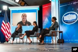 Women's soccer player Alex Morgan joins a conversation virtually with Vice President Kamala Harris, left, and other women's soccer players, during a White House Equal Pay Day summit at the Eisenhower Executive Office Building on the White House complex, March 15, 2022.
