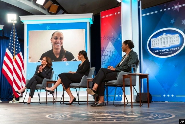 Women's soccer player Alex Morgan joins a conversation virtually with Vice President Kamala Harris, left, and other women's soccer players, during a White House Equal Pay Day summit at the Eisenhower Executive Office Building on the White House complex, March 15, 2022.