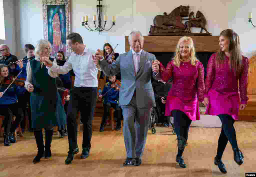 Britain&#39;s Prince Charles and Camilla, Duchess of Cornwall, join in with the dancers during their visit at the Bru Boru Cultural Centre in Cashel, County Tipperary, Ireland.