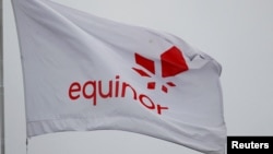 FILE - Equinor's flag flutters next to the company's headquarters in Stavanger, Norway December 5, 2019. 