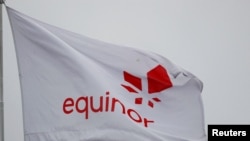 FILE - Equinor's flag flutters next to the company's headquarters in Stavanger, Norway December 5, 2019.