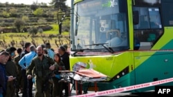 Israeli security forces inspect the scene of a stabbing attack in a bus near the Elazar settlement in the occupied West Bank on March 31, 2022.