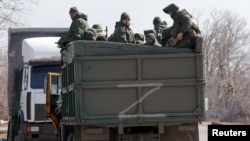 Service members of pro-Russian troops are seen in a truck during Ukraine-Russia conflict on a road near the besieged southern port city of Mariupol, Ukraine March 21, 2022.