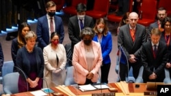 Members of the UN Security Council stand in remembrance of the recently deceased Madeleine Albright, former US Secretary of State, during a meeting before a resolution vote, March 23, 2022, at United Nations headquarters.