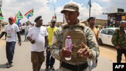 FILE: Operation Dudula leader Nhlanhla Lux Dlamini gerstures as he arrives for their Soweto Revival Launch at Diepkloof Extreme Park in Soweto on February 27, 2022. (Photo by Phill Magakoe / AFP)