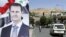 FILE - A large sign bearing the portrait of Syria's President Bashar al-Assad, with text in Arabic below reading “we have chosen you for we have loved you,” is displayed along Abo Romaneh street in the capital Damascus on May 10, 2021, ahead of presidential elections.