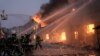 Ukrainian firefighters extinguish a blaze at a warehouse after a bombing in Kyiv, March 17, 2022. 